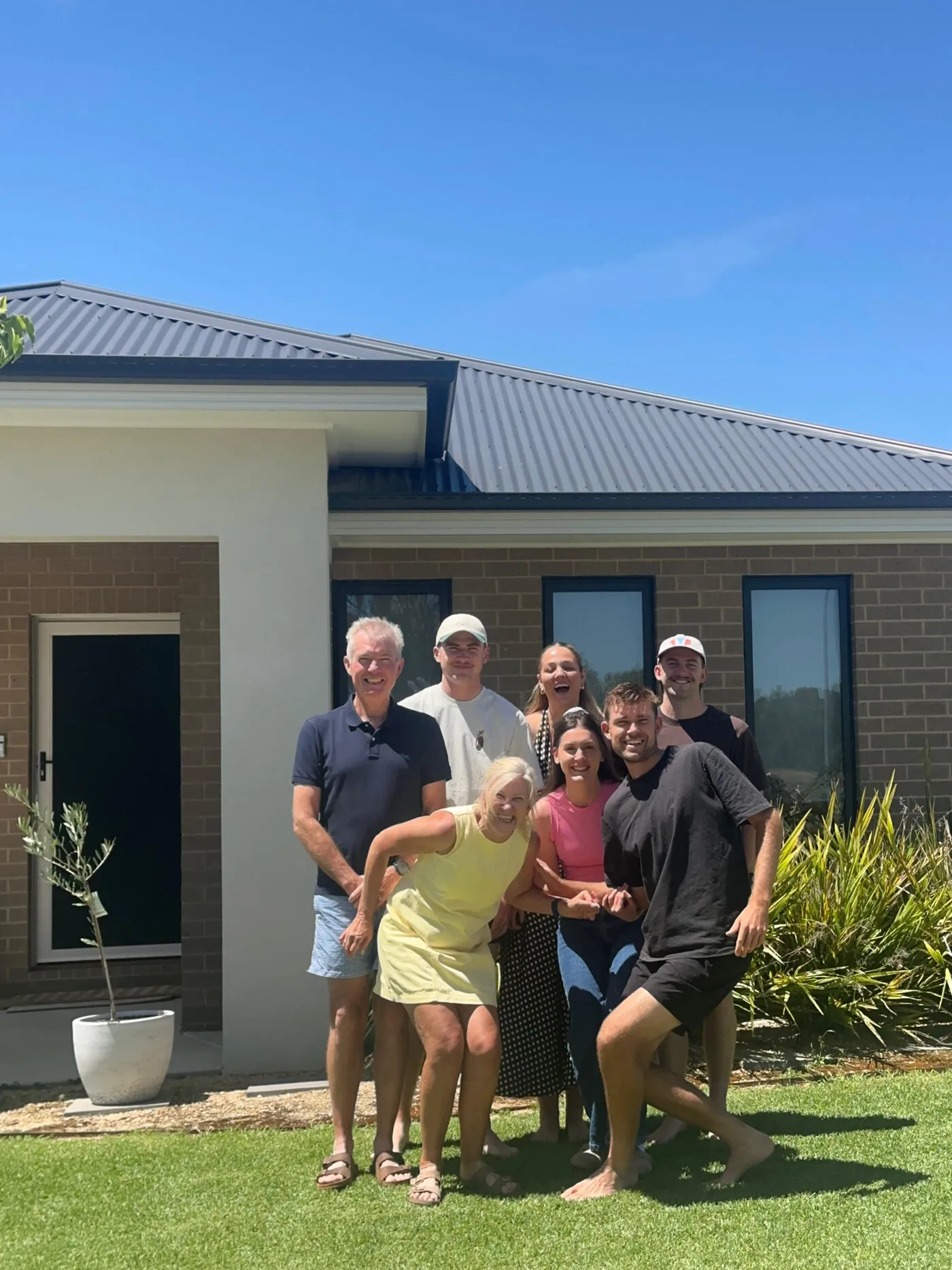 Narelle with her family outside their home